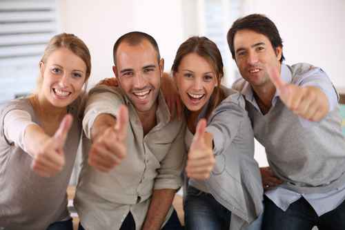 Business team shwoing thumbs up